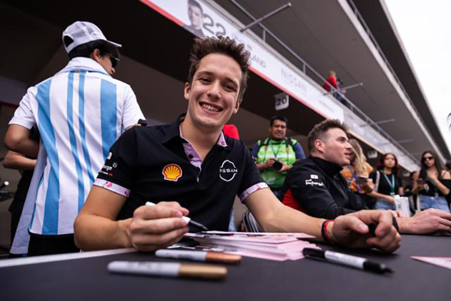 Nissan Formula E driver Sacha Fenestraz signing autographs and smiling